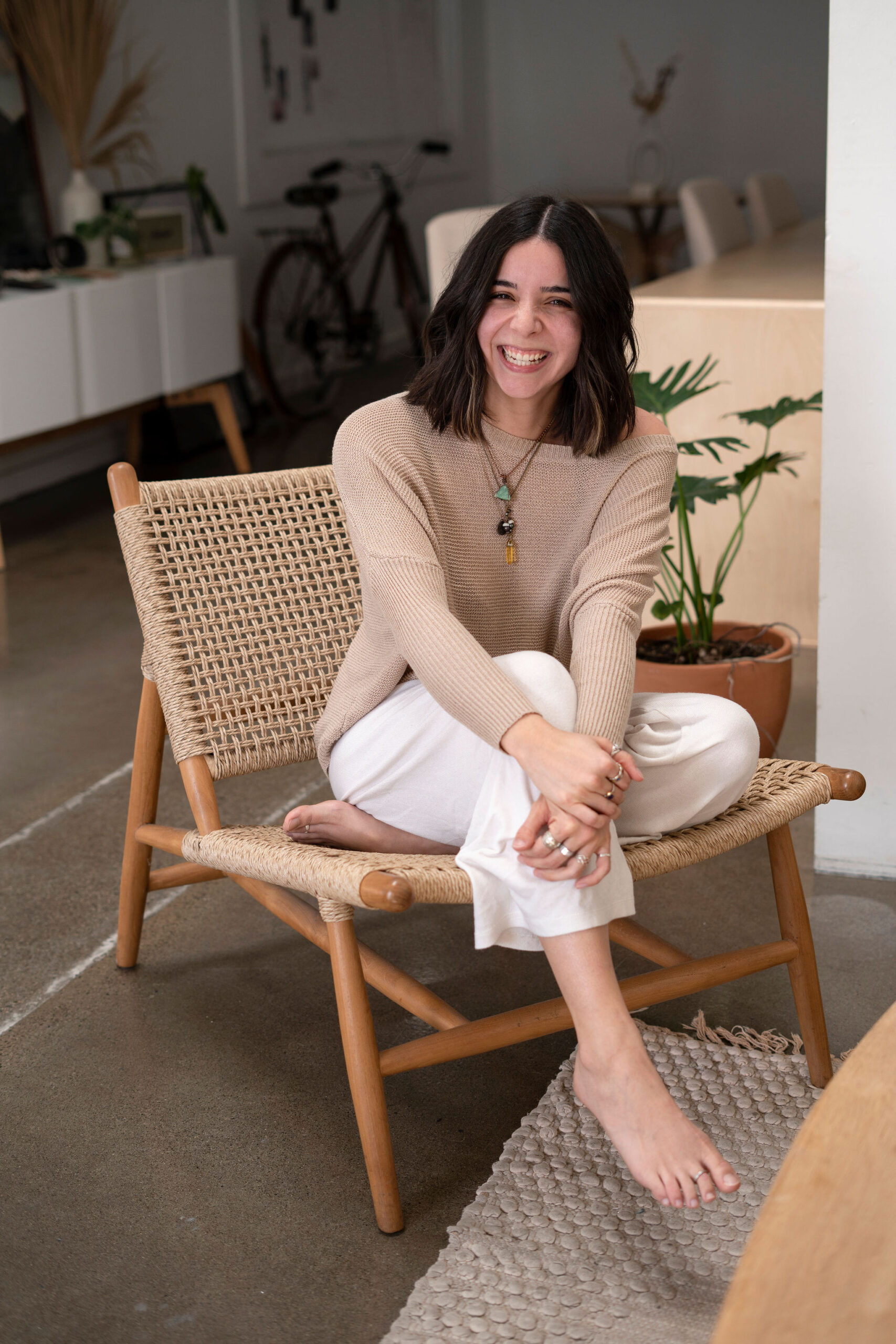 Pinterest and blogging manager, Nicole smiling sitting in a chair
